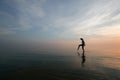 Silhouette Of Young Woman Wading In Sea