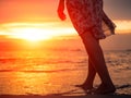 Silhouette of Young woman walking alone on the beach in the sunset Royalty Free Stock Photo