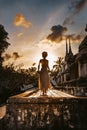 Silhouette of young woman walking at ancient temple at sunset Royalty Free Stock Photo