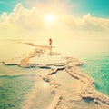 Silhouette of young woman walking on Dead Sea Royalty Free Stock Photo