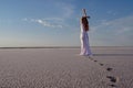 Silhouette of young woman walking on Dead Sea at sunrise. Solitude Royalty Free Stock Photo