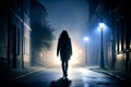 Silhouette of a young woman walking home alone at night , scared of stalker and being assault , insecurity concept Royalty Free Stock Photo