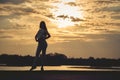 Silhouette of Young Woman Watching Sea Sunset. Breathtaking Nature Background. Toned Photo with Copy Space Royalty Free Stock Photo