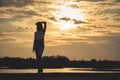 Silhouette of Young Woman Watching Sea Sunset. Breathtaking Nature Background. Toned Photo with Copy Space Royalty Free Stock Photo