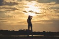 Silhouette of Young Woman Watching Sea Sunset. Breathtaking Nature Background. Toned Photo with Copy Space Royalty Free Stock Photo