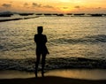 Silhouette of Young Woman Watching Sea Sunset. Drama concept. Royalty Free Stock Photo