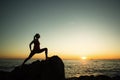 Silhouette of young yoga woman doing exercises on the ocean beach Royalty Free Stock Photo