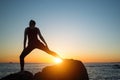 Silhouette of young yoga woman doing exercises on the ocean beach Royalty Free Stock Photo