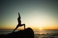 Silhouette of young yoga woman doing exercises on the ocean beach Royalty Free Stock Photo