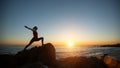 Silhouette young yoga woman doing fitness exercises on the sea beach Royalty Free Stock Photo