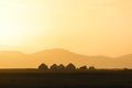 Silhouette of a yurt settlement at Song Kul lake in Kyrgyzstan at sunset
