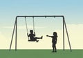 Silhouetted against a softly lit sky, two children interact with a swing set. One child sits on the Royalty Free Stock Photo