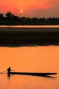 Silhouetted boat on Mekong river at sunset Royalty Free Stock Photo