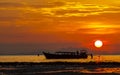 Silhouetted of boat in the sea at sunset, Krabi, Thailand.