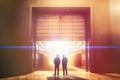 Two Businessmen Silhouetted Standing Near Opening of Large Commercial Industrial Building - Generative AI