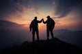 Silhouetted climbers atop a mountain peak, flag waving, symbolize triumphant success Royalty Free Stock Photo