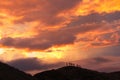 Silhouetted climbers on volcanic rim of Masaya volcano at sunset