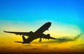 Silhouetted commercial airplane flying