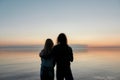 Silhouetted couple embracing while watching beautiful sunset on the river together Royalty Free Stock Photo