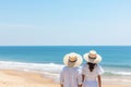 Silhouetted couple enjoying a picturesque beach day with sparkling waves in the background