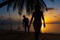 Silhouetted couple in love walks on the beach during sunset Royalty Free Stock Photo