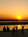 Silhouetted couple watching sunset