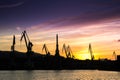 Silhouetted cranes at shipyard, Royalty Free Stock Photo
