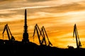 Silhouetted cranes at shipyard, Royalty Free Stock Photo