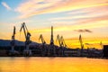 Silhouetted cranes at shipyard, Royalty Free Stock Photo