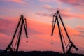 Silhouetted cranes at shipyard, Royalty Free Stock Photo