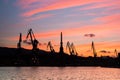 Silhouetted cranes at shipyard, Royalty Free Stock Photo