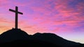 Silhouetted cross on hillside
