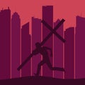 A silhouetted figure carrying a large cross runs on a ridge with a skyline