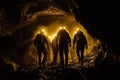 Silhouetted Figures Exploring a Dark Cave with Headlamps Royalty Free Stock Photo