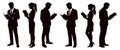 Silhouetted figures reading books in a group setting representing knowledge and learning in a professional environment for Royalty Free Stock Photo