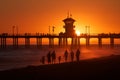 Silhouetted group of people walking on a beach at sunset,