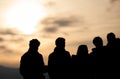 Silhouetted group in sunset sky