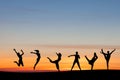Silhouetted group tumbling and dancing in sunset Royalty Free Stock Photo