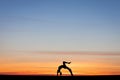 Silhouetted gymnast doing bow in sunset Royalty Free Stock Photo