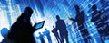 Silhouetted hacker with a laptop against an abstract digital background, depicting cybersecurity threats