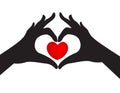Silhouetted hands and love heart