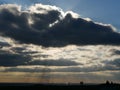 A Silhouetted image from the top of the slope overgrown with a meadow of the Hoheward dump in the Ruhr area in Germany. Dramatic