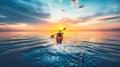 Silhouetted kayaker paddling at sunset on the sea recreational water sports adventure