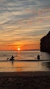 Silhouetted kayakers on ballybunion beach on the Wild Atlantic Way Royalty Free Stock Photo