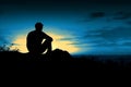 Silhouetted male figure on a hill, admiring the illuminated night sky - Ai generated