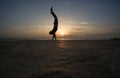 Silhouetted man doing handstand in sunset Royalty Free Stock Photo