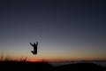 Silhouetted of man jumping in sunset Royalty Free Stock Photo