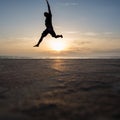 Silhouetted man jumping in sunset Royalty Free Stock Photo