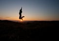 Silhouetted man jumping in sunset Royalty Free Stock Photo