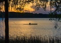 Silhouetted man rows through pond in Payne`s Prairie.CR2 Royalty Free Stock Photo